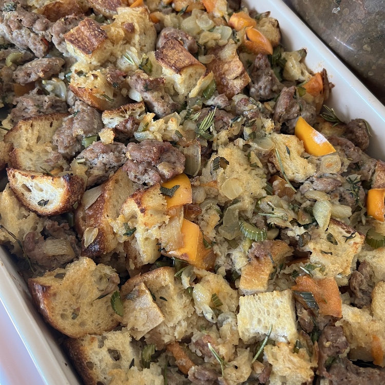 The baked stuffing in a white dish